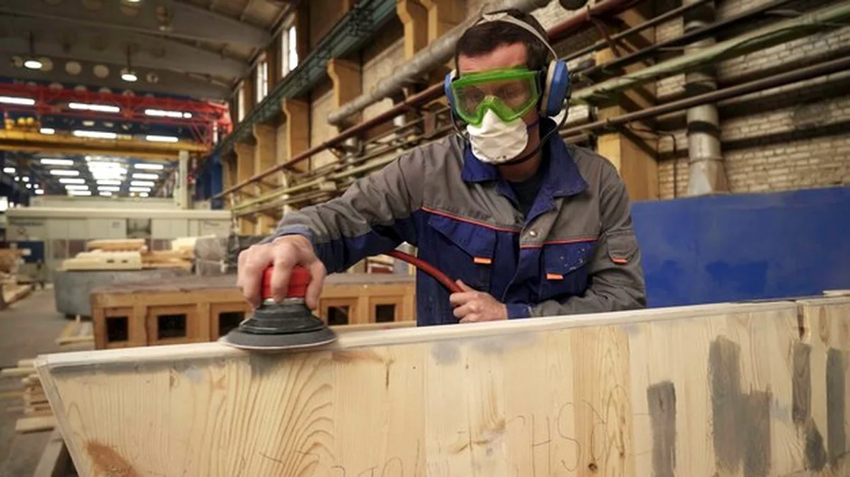 Rzemieślnik szlifuje drewno w warsztacie